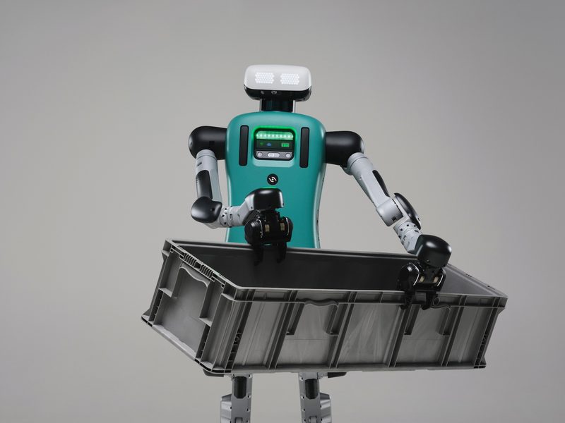 Agility Robotics' Digit humanoid robot holding a grey crate