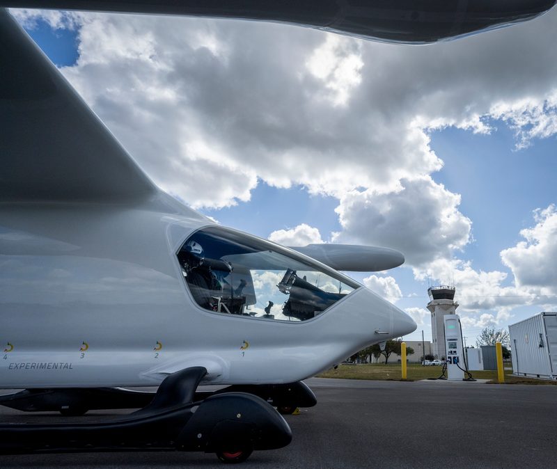 BETA Technologies' white ALIA electric aircraft parked on a flightline under clouds